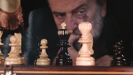 Adult-Man-Playing-Chess,-Thinking-Of-Best-Strategy-Before-Moving-Chess-Piece