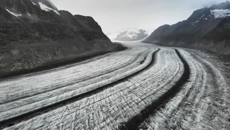 Aerial-flyover-over-the-longest-glacier-in-the-Alps---the-Aletsch-glacier-in-Valais,-Switzerland---while-backing-away-from-Jungfrau