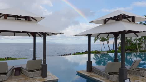 Rainbow-over-the-ocean-and-infinity-pool---pan-down