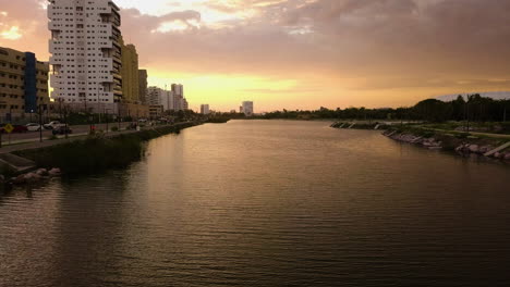 Reverse-shot-of-a-city-water-canal-sunset-in-Mazatlan,-Mexico