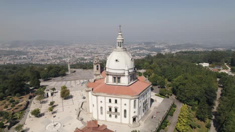 Aerial-panning-shot-capturing-monumental-architecture-sanctuary-of-sameiro-and-scenic-cityscape
