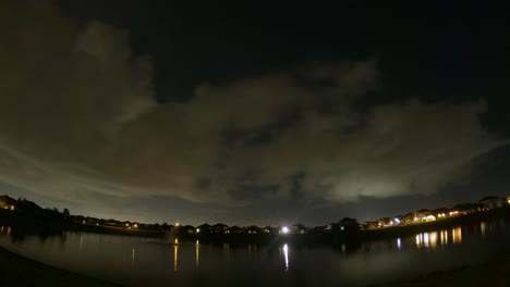 Clouds-cross-the-sky-in-different-directions-in-this-day-to-night-to-day-time-lapse-with-the-sky-and-clouds-reflecting-off-the-lake