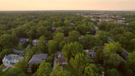Pan-left-over-beautiful-Clayton-neighborhood-houses-and-trees-with-downtown-skyline-on-horizon-at-sunset