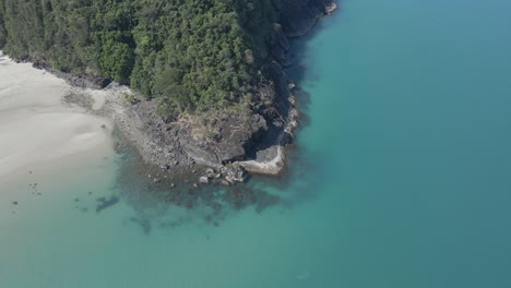 Aerial-View-Of-The-Green-Forest-Covered-Headland-Of-Myall-Beach-In-Cape-Tribulation,-QLD,-Australia