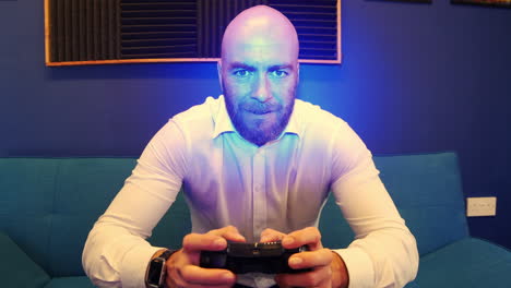 A-bearded-bald-Man-On-Couch-sofa-Playing-A-Video-Game
