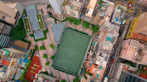 Football-Field---Aerial-View-Of-Outdoor-Football-Pitch-With-Cityscape-And-Traffic-In-Hong-Kong