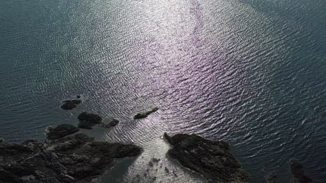 Aerial-footage-showing-the-Scottish-coastline-with-beautiful-shimmering-water-in-the-evening-light