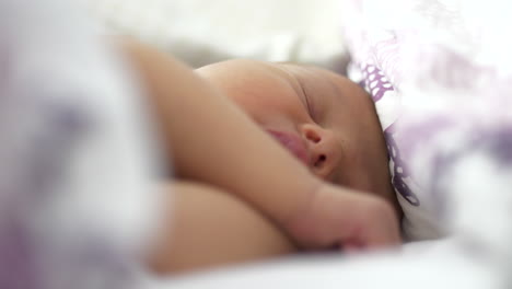 Close-up-of-adorable-newborn-sleeping-peacefully.-Rack-focus