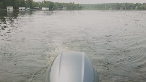 Outboard-Motor-Of-Sailing-Boat-With-Traces-On-A-Tranquil-Lake