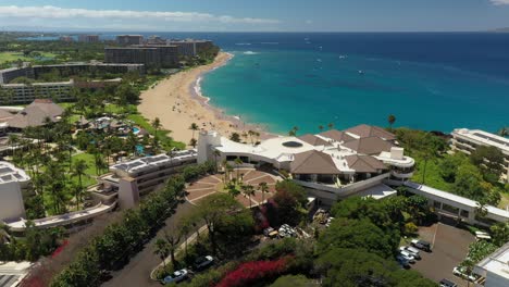 Rotating-aerial-view-of-Kaanapali-beach-over-the-Sheraton-hotel-on-the-island-of-Maui,-Hawaii
