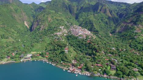 Drone-aerial-footage-of-volcanic-lakeside-indigenous-town-Santa-Cruz-La-Laguna,-Guatemala-in-Lake-Atitlan-in-Central-America-highlands