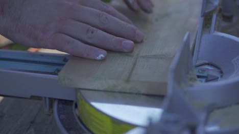 Slow-Motion-Shot-Of-Pine-Wood-Being-Cut-On-A-Mitre-Saw