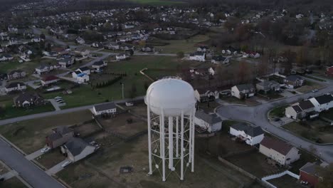 Aerial-Time-lapse-of-a-tall-water-tower-near-a-busy-highway-in-Clarksville-Tennessee,-Orbit-Shot