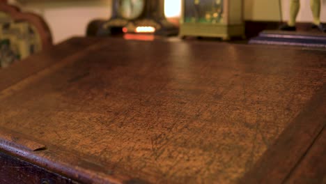 clsoe-up-of-antique-writing-table-visible-marks-scratches-it-was-used-heavily-back-in-the-days-slow-motion