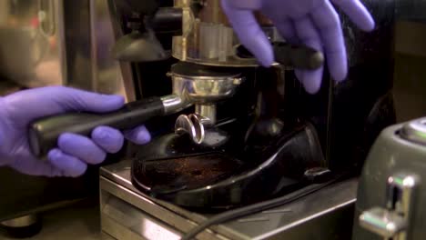 close-up-of-barista-with-purple-gloves-is-preparing-coffee-and-really-taking-care-that-its-perfect-slow-motion