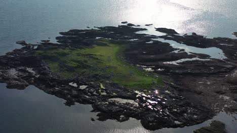Aerial-view-looking-down-onto-a-rocky-outcrop-on-the-Scottish-West-coast