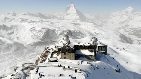 Aerial-flyover-away-from-Gornergrat-with-a-view-of-the-Matterhorn-during-winter