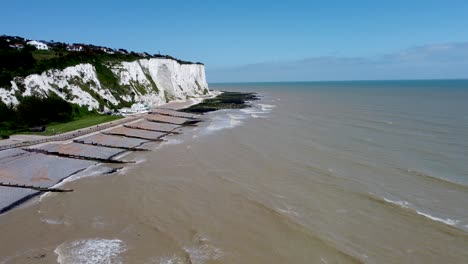 4K-drone-video-of-small-waves-hitting-the-base-of-the-white-cliffs-near-Dover,-Kent,-England