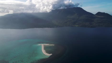 Tropical-reef-in-sea-with-white-sand-bar-on-top,-view-of-Camiguin-island