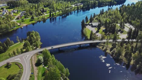 Car-Drives-On-The-Road-Bridge-Over-Vasterdalalven-River-In-Vansbro,-Dalarna,-Sweden