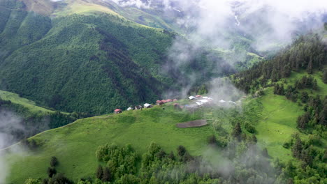 Cinematic-rotating-drone-shot-of-a-small-village-on-a-mountain-top-in-Tusheti-Village-in-Georgia