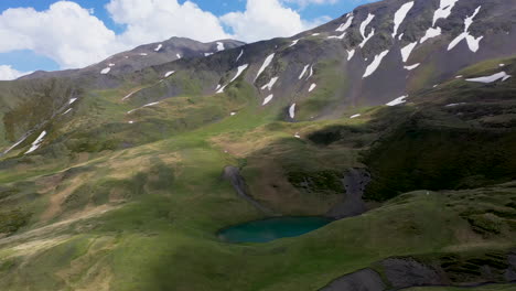 Cinematic-wide-drone-shot-of-Oreit-Lake-in-Tusheti-Georgia,-in-the-Caucasus-mountains