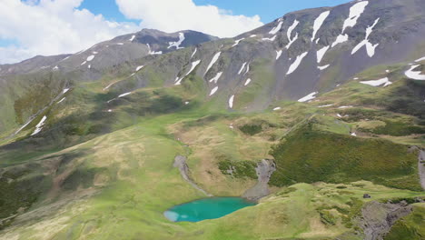 Cinematic-wide-revealing-drone-shot-of-Oreit-Lake-in-Tusheti-Georgia,-in-the-Caucasus-mountains