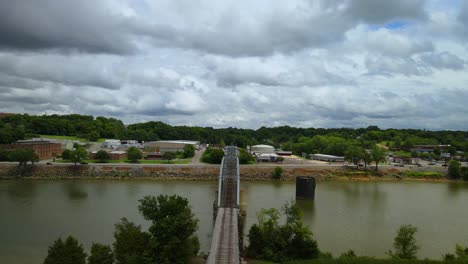 Aerial-flyover-of-a-swing-bridge-on-the-Cumberland-River-in-Clarksville,-Tennessee