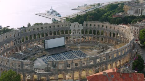 Aerial-tracking-shot-over-the-Pula-Arena-in-Pula,-Croatia-on-a-bright-afternoon
