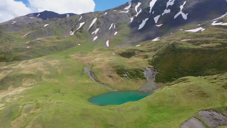 Cinematic-wide-rising-drone-shot-of-Oreit-Lake-in-Tusheti-Georgia,-in-the-Caucasus-mountains