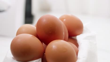 Varios-Huevos-Orgánicos-Frescos-En-Un-Recipiente-Giratorio-Sobre-Papel-Blanco-Para-Envolver-Para-Hacer-Comida