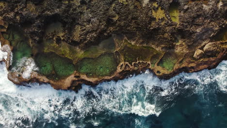 Aerial-pullout-of-natural-rock-pools-at-Cap-des-pins-in-Lifou-island,-New-Caledonia