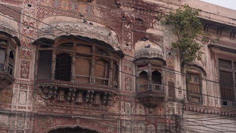 A-view-of-The-Haveli-of-Nau-Nihal-Singh-located-in-Lahore,-Pakistan,-the-haveli's-profusely-decorated-with-frescoes-painted-in-the-vivid-Kangra-style,-and-the-other-pierced-with-numerous-windows