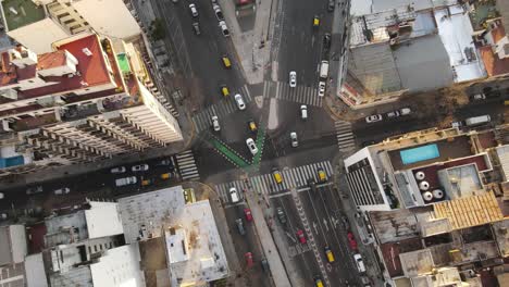 Aerial-top-down-shot-showing-road-fork-with-traffic-surrounded-by-old-skyscraper-buildings-in-Buenos-Aires,Argentina