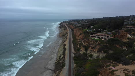 Aerial-View-Of-Amtrak-Pacific-Surfliner-Train-Tracks-Along-The-Del-Mar-Coast-In-California