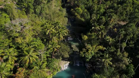 Above-Cambugahay-Falls-in-dense-tropical-jungle,-blue-water-pool,-aerial
