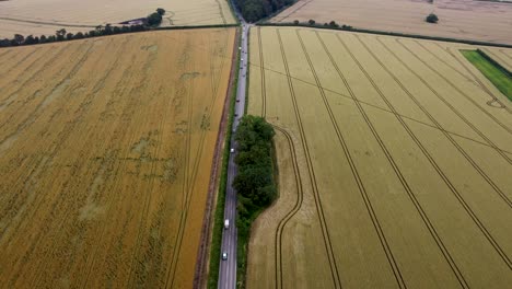 4K-drone-video-flying-over-the-top-on-a-quiet-country-road-in-Kent,-England