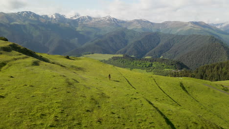 Cinematic-drone-shot-of-man-horseback-riding-in-the-mountains-of-upper-Omalo,-Tusheti,-Georgia