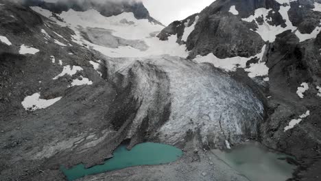 Aerial-flyover-from-side-to-side-facing-Witenwasseren-glacier-and-its-two-glacial-lakes-in-Uri,-Switzerland
