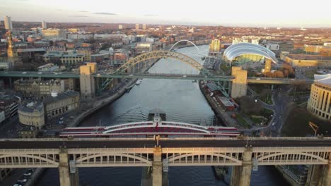 Tracking-shot-down-the-centre-of-the-River-Tyne-in-Newcastle,-featuring-the-High-Level-Bridge,-Swing-Bridge,-Tyne-Bridge,-and-the-Millennium-Bridge
