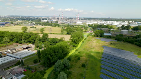 Industrial-area-near-Gdansk-in-Poland,-solar-panel-farm,-oil-refinery,-aerial