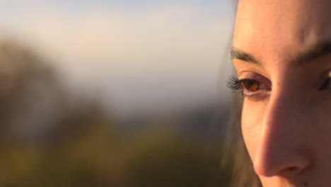 Close-up-of-a-woman's-eye-as-she-takes-in-and-enjoys-the-beautiful-sites-of-nature-on-a-sunny-day