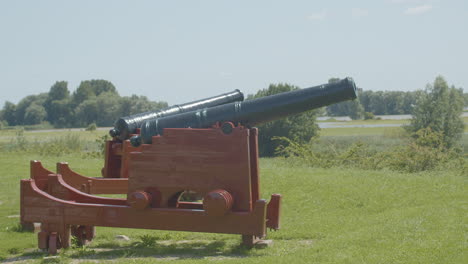 Wide-shot-of-old-cannons-overlooking-typical-Dutch-landscape
