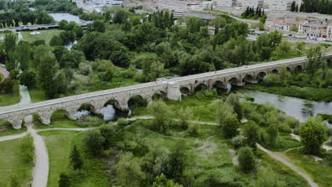 Aerial-View-Of-Puente-Mayor-Del-Tormes-Crossing-The-Tormes-River-In-Salamanca,-Spain