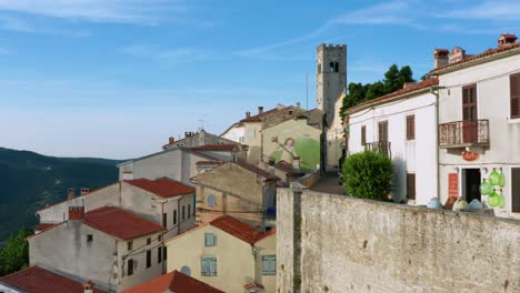 Flyover-shot-of-the-old-walled-town-of-Motovun,-Croatia-on-a-bright-afternoon