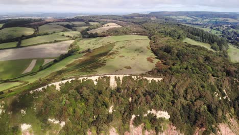 Aerial-View-Of-Tree-Lined-Coastal-Jurassic-Cliffs-near-Sidmouth-Devon-UK