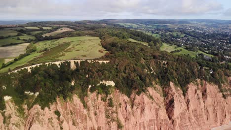 Aerial-View-Of-Coastal-Jurassic-Cliffs-East-Devon-England-Slow-Dolly-Back,-Establishing-Shot