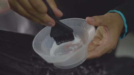 barber-preparing-hair-mixture-with-brush