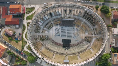 Aerial-shot-trucking-over-the-Pula-Arena-in-Pula,-Croatia-on-a-bright-day