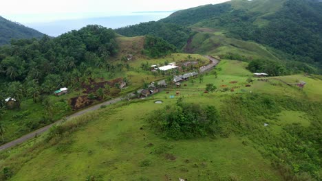 Vegetated-Mountain-With-Traditional-Houses-At-The-Coastline-Of-Southern-Leyte-In-The-Philippines